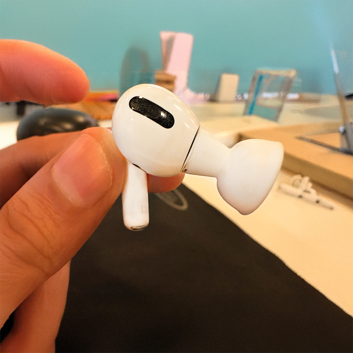 Hold the AirPod by head and unroll the ear tip